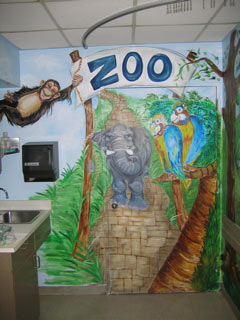 Look at this gorgeous, hand-painted wall that was beautifully painted by our volunteer artists - with a monkey, elephant, parakeets, and a pathway... where there is a monkey, trees, and a turtle can partially be seen on the right wall of Mt. Sinai's Pediatric ER Treatment Room