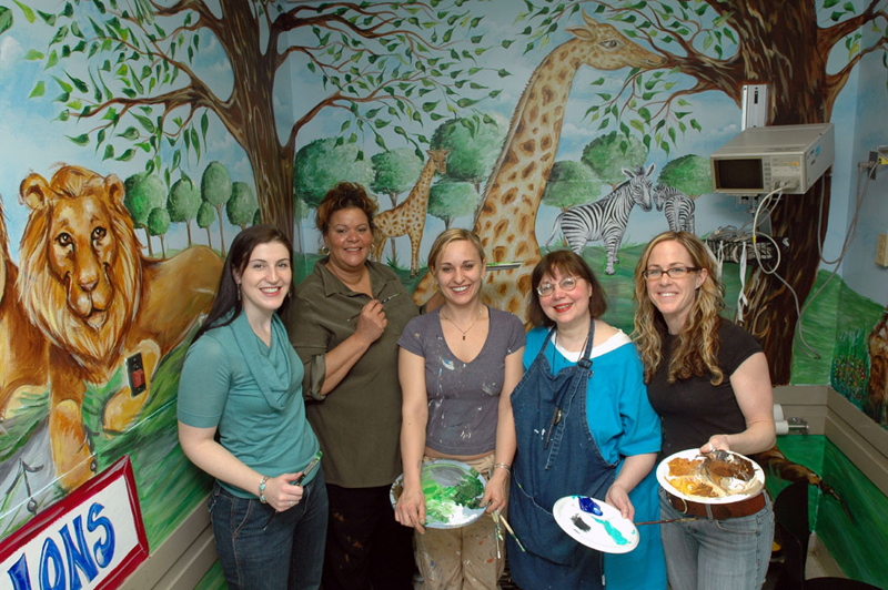 Mt Sinai - Volunteers in Standing in Front of Amazing Zoo Mural in Pediatric ER Exam Room