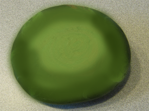 Paint the entire rock green with the green paint.
