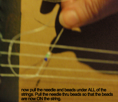 Now pull the needle and beads under ALL of the strings.