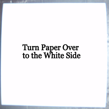 Turn paper over to the white side.