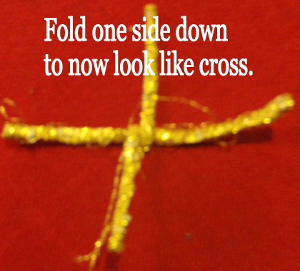 Fold one side down to now look like a cross.