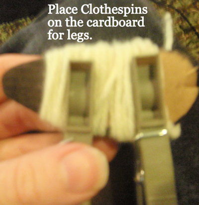 Place clothespins on the cardboard for legs.