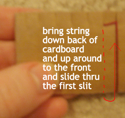 Bring string down back of cardboard and up around to the front