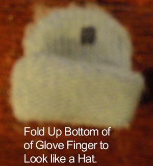 Fold up bottom of glove finger to look like a hat.
