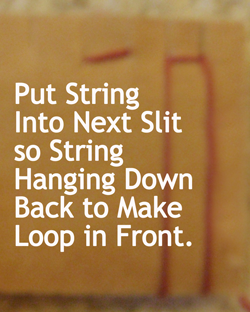 Put string into next slit so string hanging down back to make loop in front.