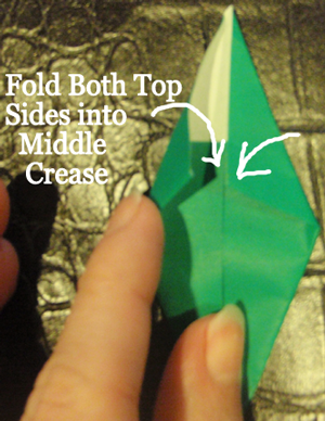 Fold both top sides into middle crease.