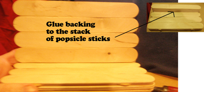 Glue backing to the stack of Popsicle sticks.