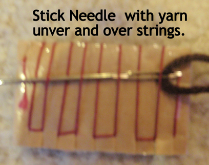 Stick needle with yarn under and over strings.