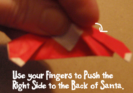 Use your fingers to push the right side to the back of Santa.