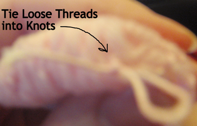 Tie loose threads into knots.