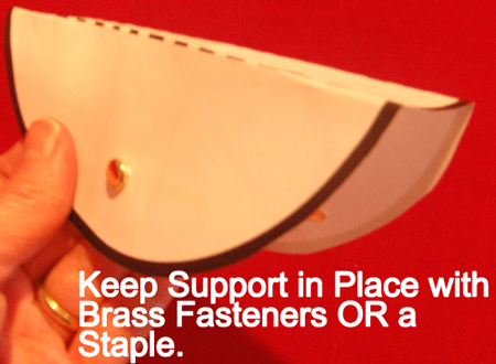 Keep support in place with brass fasteners or a staple.