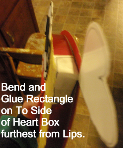 Bend and glue rectangle on to side of heart box furthest from lips.