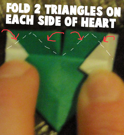 Fold 2 triangles on each side of heart.