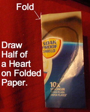Draw half of a heart on folded paper.