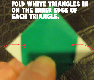 Fold white triangles in on the inner edge of each triangle.
