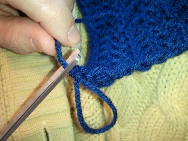 Once knot is made you can cut off remaining string of yarn and loop of yarn.