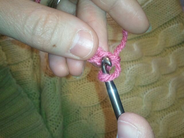 Push your hook through the first stitch of your crocheted blanket.