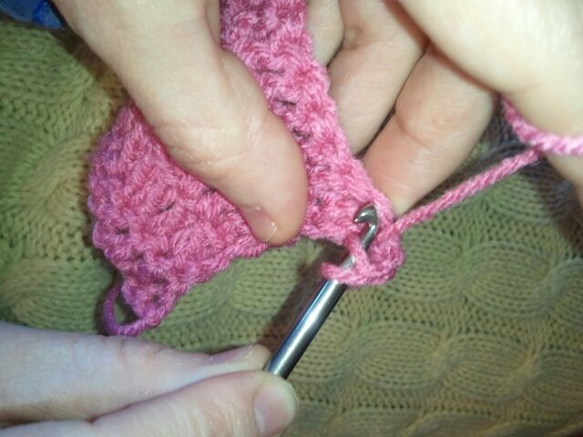 go into the first stitch of the previous row of the crocheted blanket like you did in step 10.