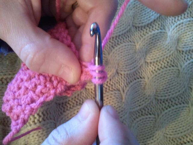 Pull the hook through the first loop on the crochet hook. 