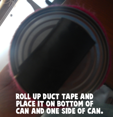 Roll up duct tape and place it on bottom of can and on one side of can.
