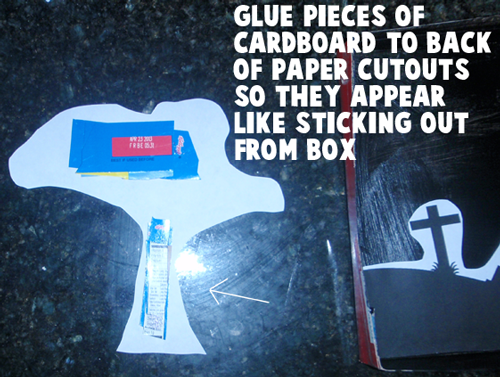 Glue pieces of cardboard to back of paper cutouts so they appear like they are sticking out from box.