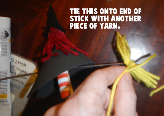Tie this on to end of stick with another piece of yarn.