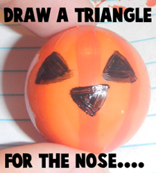 Draw a triangle for the nose.