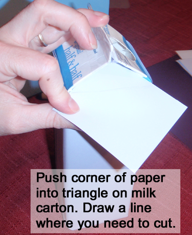 Push corner of paper into triangle on milk carton.