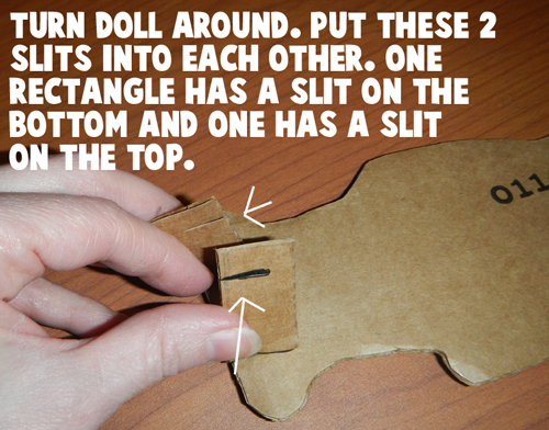 Turn doll around.  Put these two slits into each other.