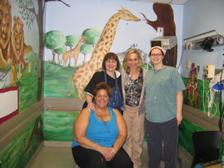 Mt Sinai Zoo Mural Volunteers standing in front of zoo mural